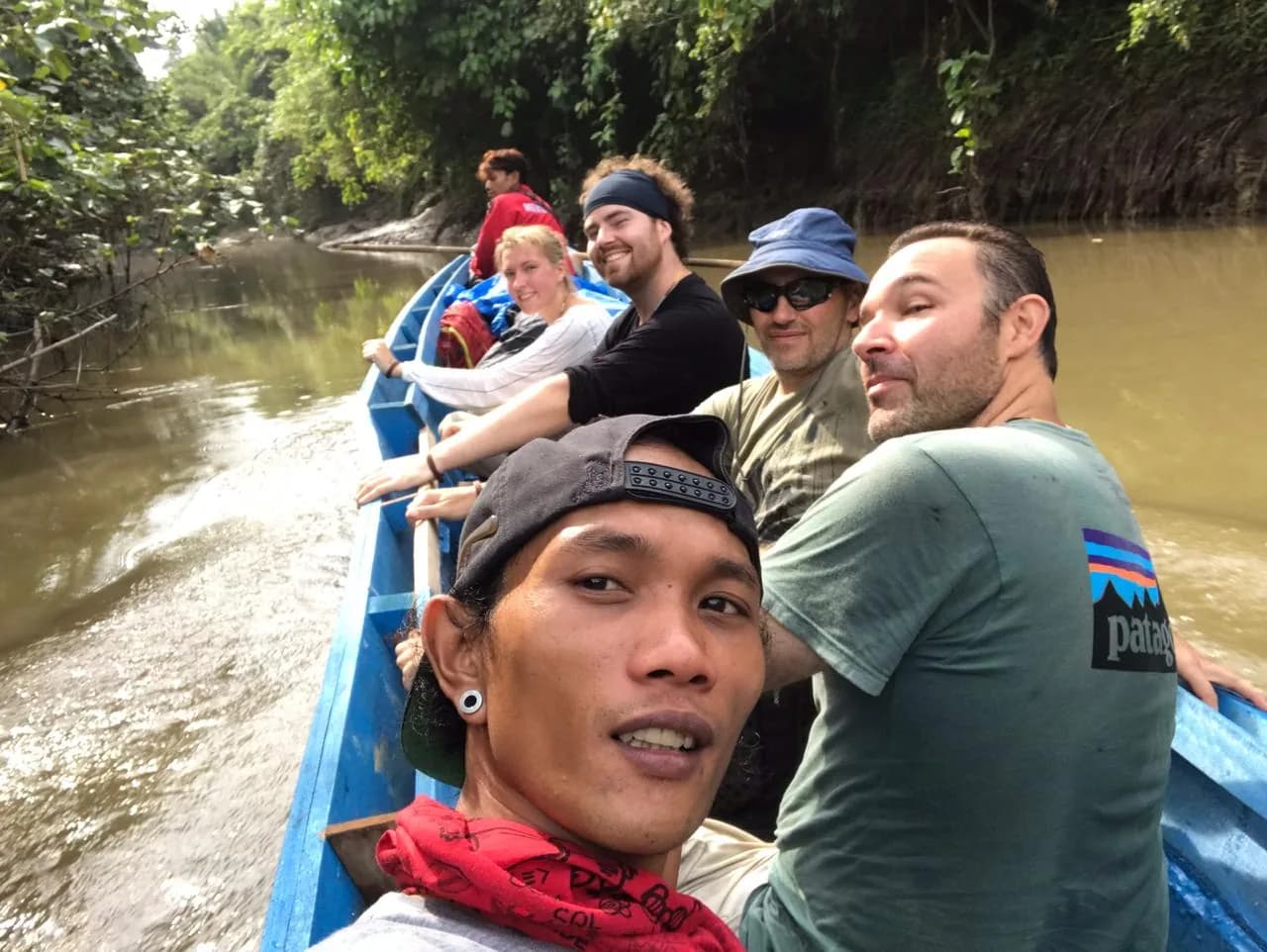 Guests riding a canoe through the Siberut river